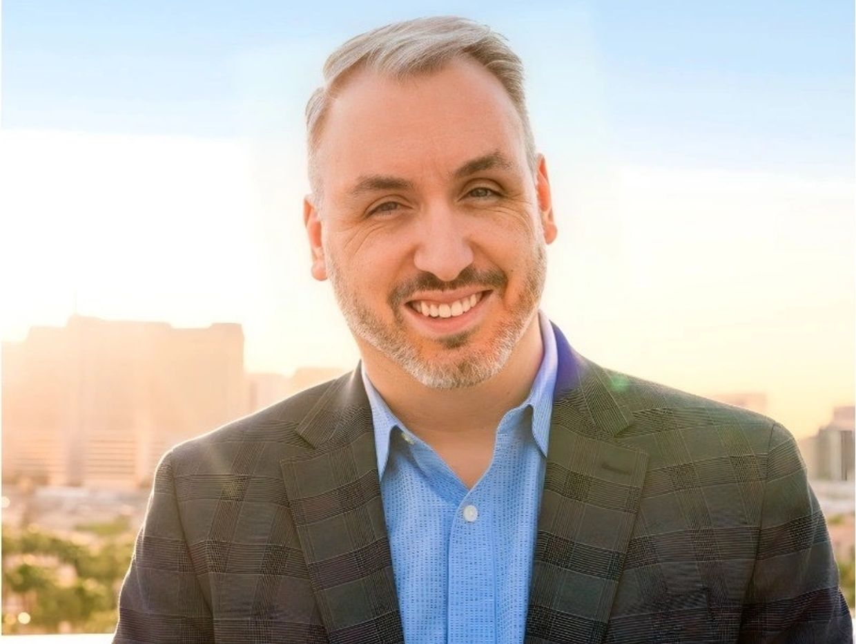 Matt Perrault smiling in a blazer